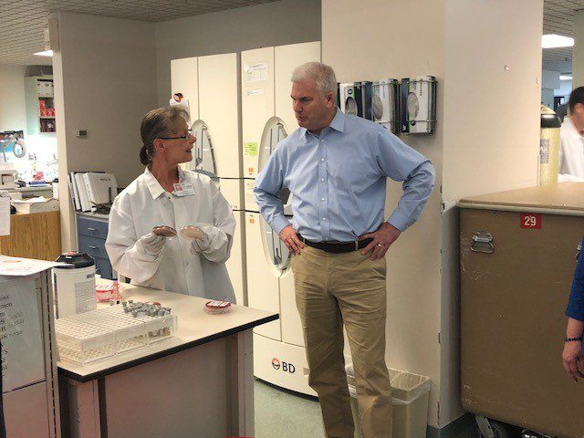 Edith Burlingame gives a tour of the laboratory to Minnesota Representative Tom Emmer