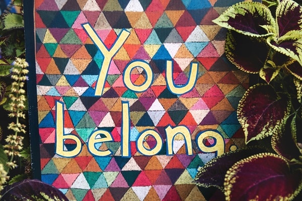 Colorful sign that reads, "You belong."